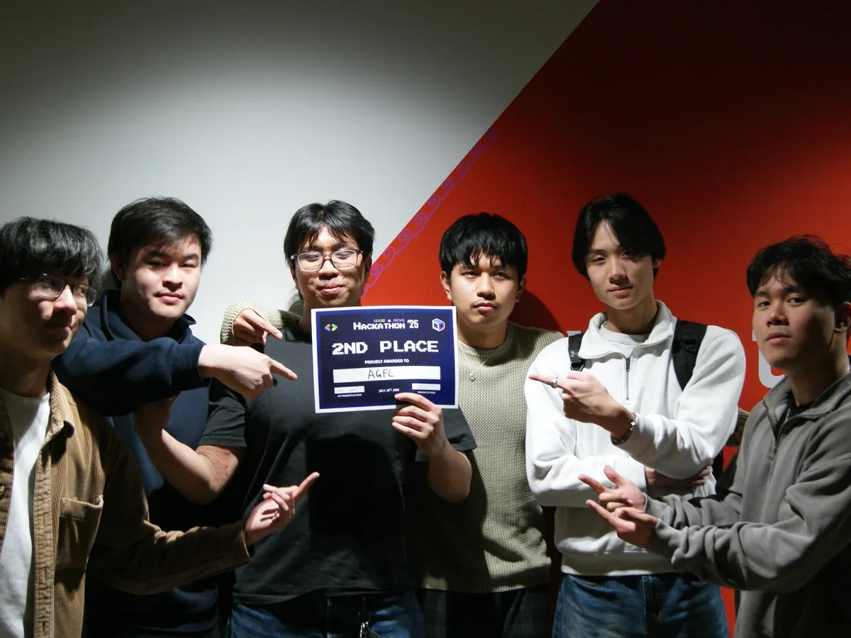 Six friends pointing at a 2nd place certificate from Hackathon 2025, awarded to AGFC